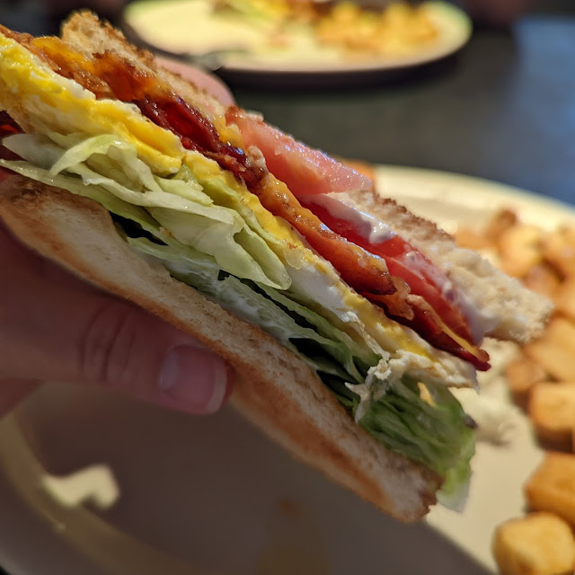 Stacked diner club sandwich with breakfast potatoes